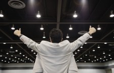 Businessman on Stage Raising Arms