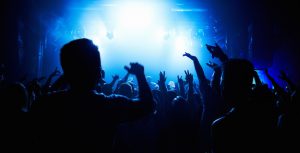 A crowd of people watching a band play on stage at a nightclub. This concert was created for the sole purpose of this photo shoot, featuring 300 models and 3 live bands. All people in this shoot are model released.http://195.154.178.81/DATA/i_collage/pi/shoots/782423.jpg