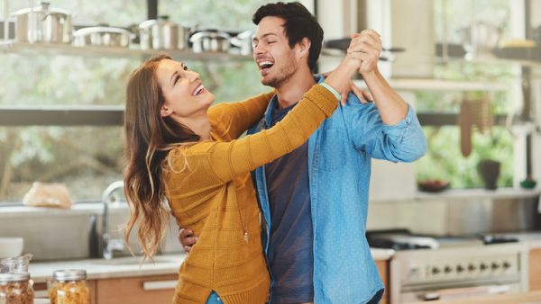 Shot of an affectionate young couple dancing in their kitchen